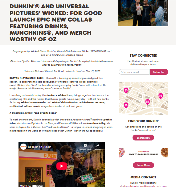 A screenshot of a Dunkin’ press release about a ‘Wicked’ movie collaboration, showing themed drinks, merch, and a photo of two people holding beverages on a film set.